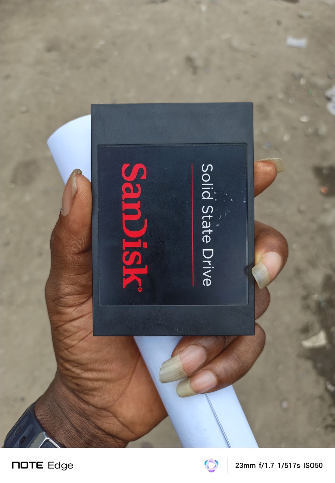 SanDisk SSD held during a storage upgrade